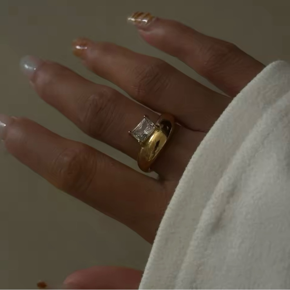 Asymmetrical Gold ring with emerald cut stone
